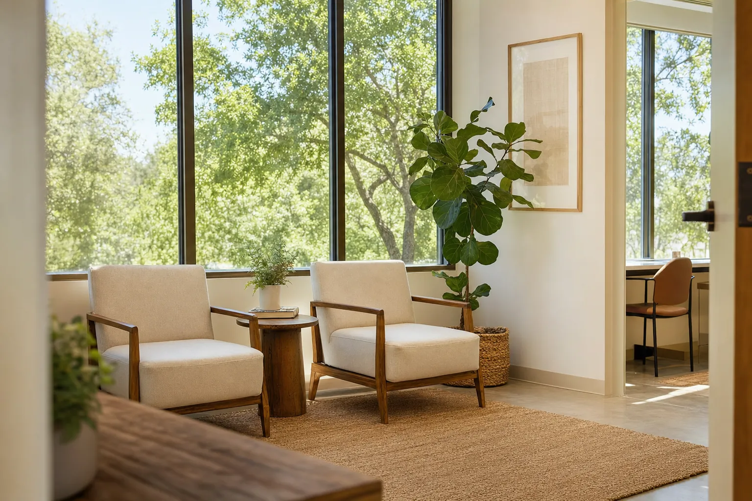 A bright waiting area with tall windows onto trees