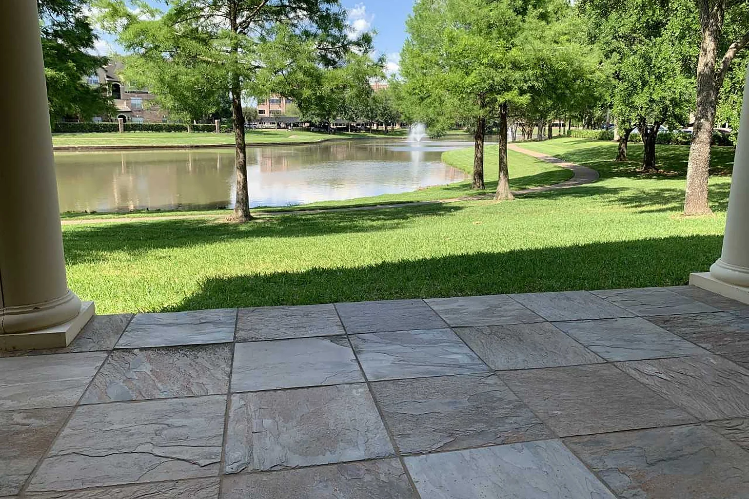 The view from Sugar Land Counseling Center's covered porch across the lawn to the lake and fountain