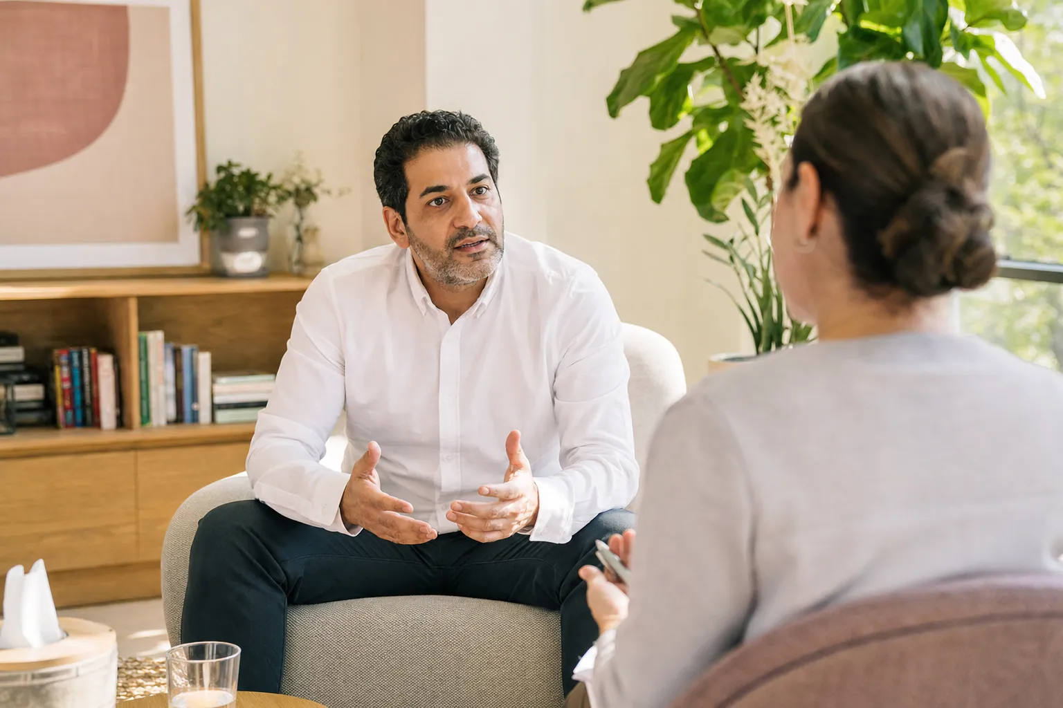 A man talking with a counselor in a bright office